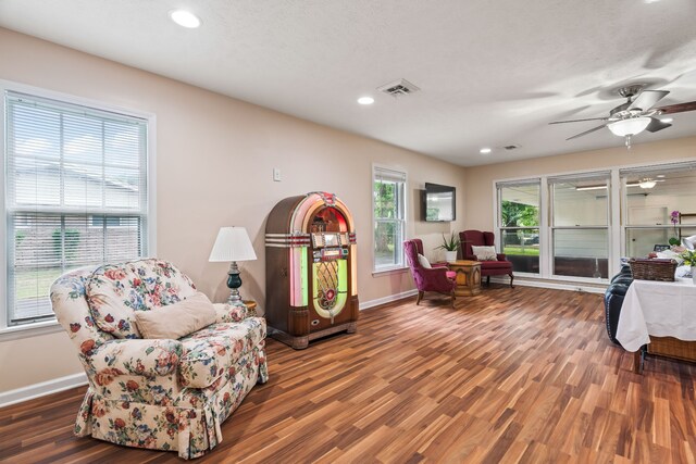 sitting room with plenty of natural light, dark hardwood / wood-style flooring, and ceiling fan