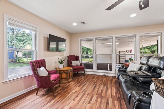 living room featuring ceiling fan and hardwood / wood-style flooring