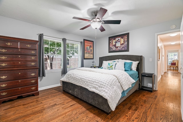 bedroom featuring dark hardwood / wood-style flooring and ceiling fan