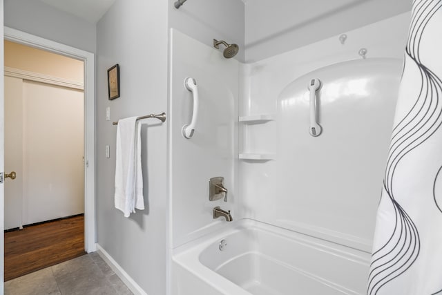 bathroom with bathing tub / shower combination and tile floors