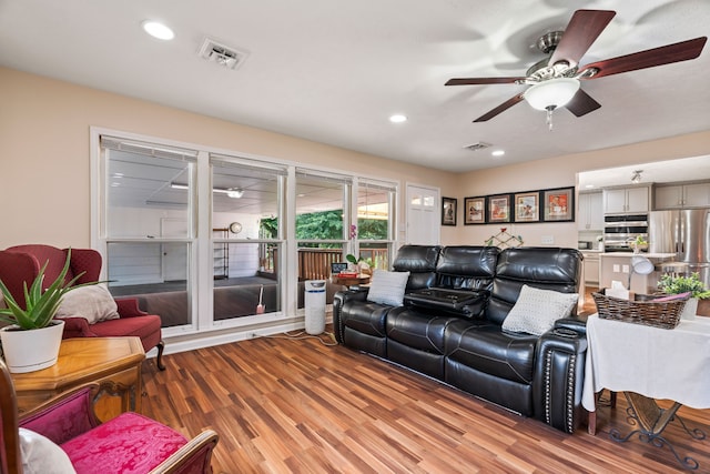 living room featuring ceiling fan and wood-type flooring