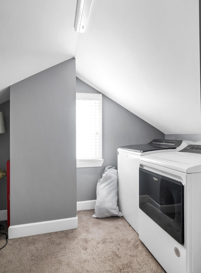 carpeted bedroom with lofted ceiling and separate washer and dryer