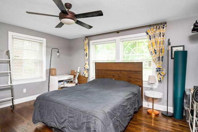 bedroom with dark hardwood / wood-style floors and ceiling fan