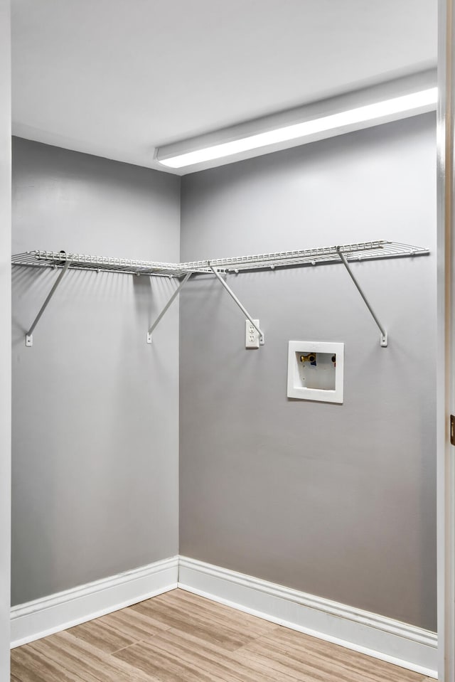 walk in closet featuring light hardwood / wood-style floors