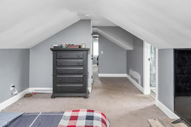 bonus room featuring lofted ceiling and light carpet