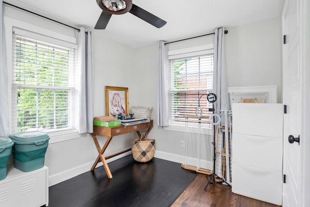 miscellaneous room featuring ceiling fan, dark hardwood / wood-style floors, and a healthy amount of sunlight