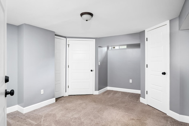 spare room featuring dark colored carpet