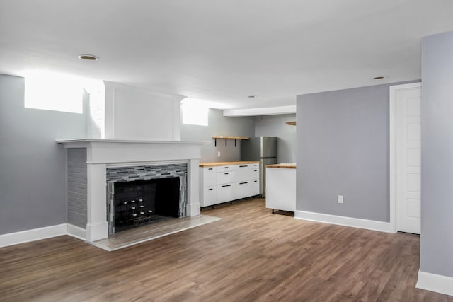 unfurnished living room featuring hardwood / wood-style floors and a wealth of natural light