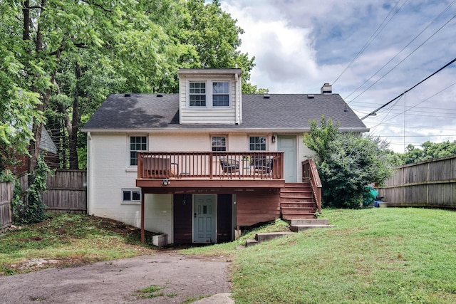 back of house with a deck and a yard