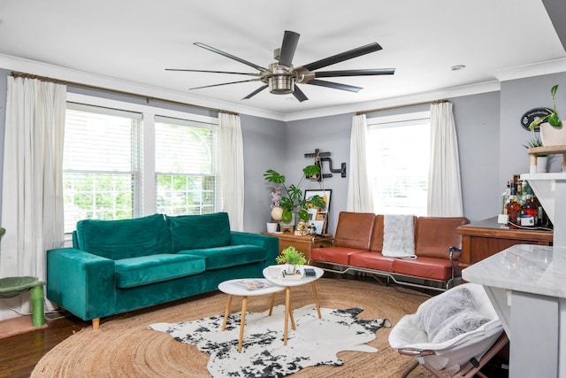 living room featuring dark hardwood / wood-style flooring, ceiling fan, ornamental molding, and a wealth of natural light