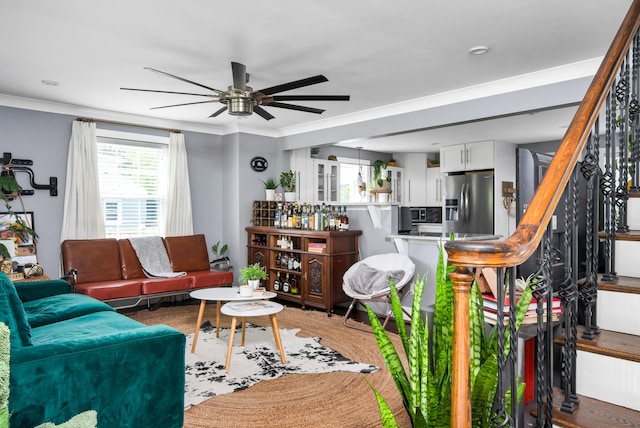 living room featuring crown molding and ceiling fan