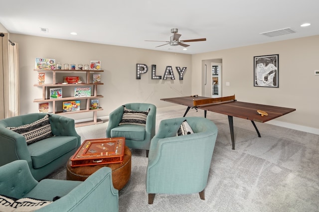 living room featuring light colored carpet and ceiling fan