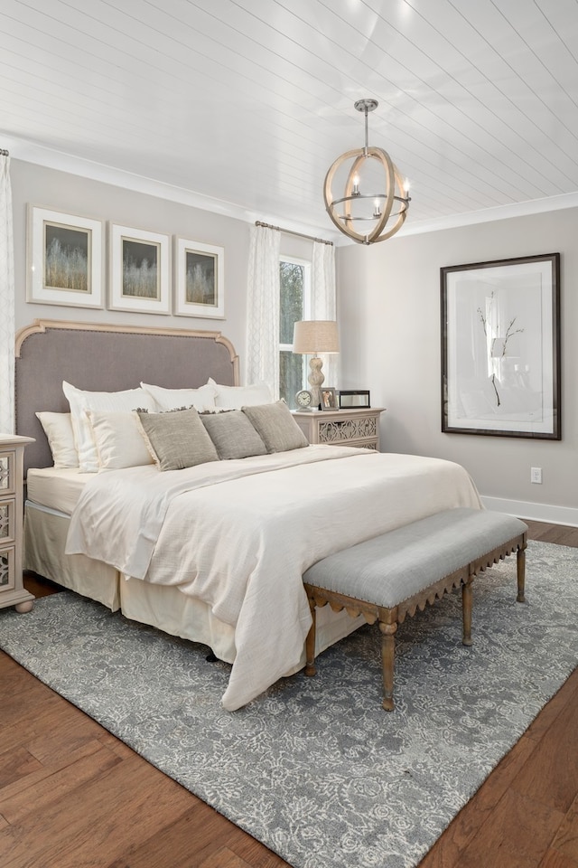 bedroom with crown molding, wood-type flooring, and a chandelier