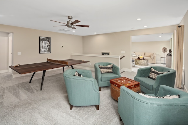 living room featuring light carpet and ceiling fan