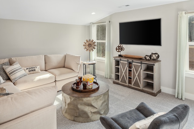 living room with light colored carpet and vaulted ceiling