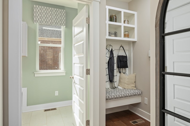 mudroom featuring light tile floors