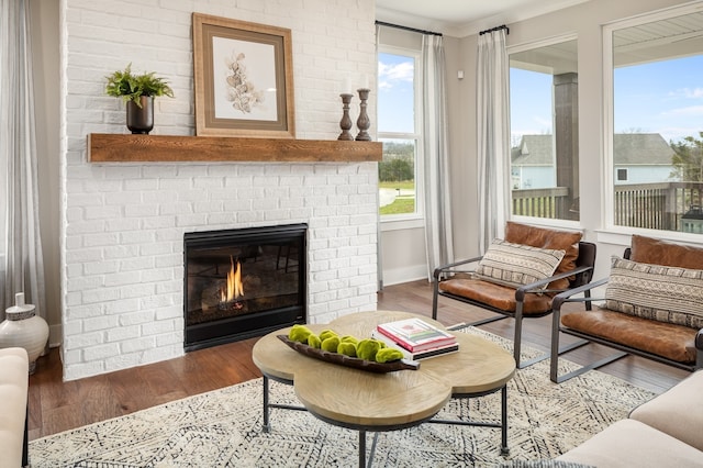 living room with dark hardwood / wood-style flooring and a brick fireplace