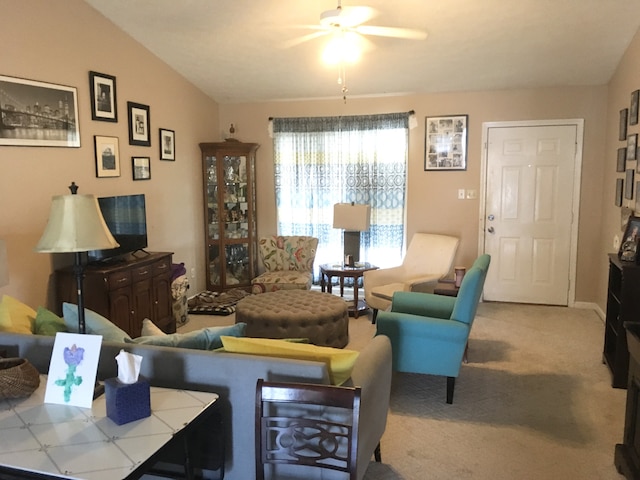 living room with light carpet, ceiling fan, and lofted ceiling