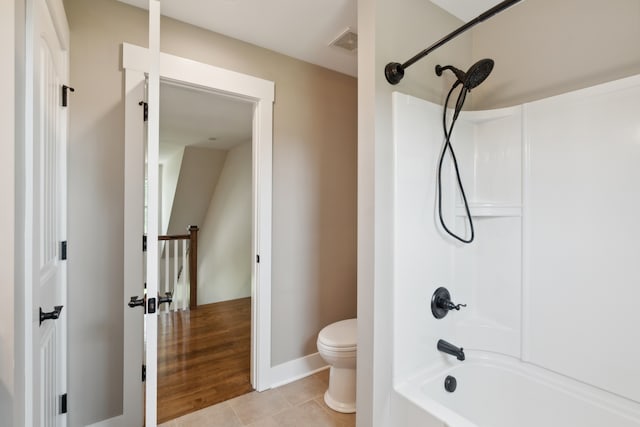 bathroom with shower / bath combination, tile flooring, and toilet