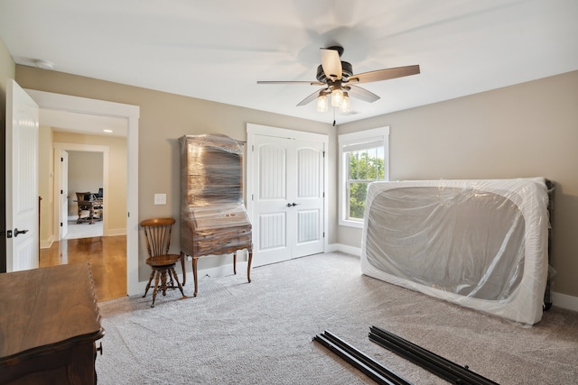 carpeted bedroom featuring ceiling fan and a closet