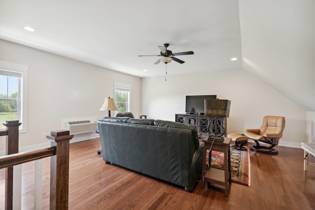 living room with ceiling fan, lofted ceiling, and light wood-type flooring