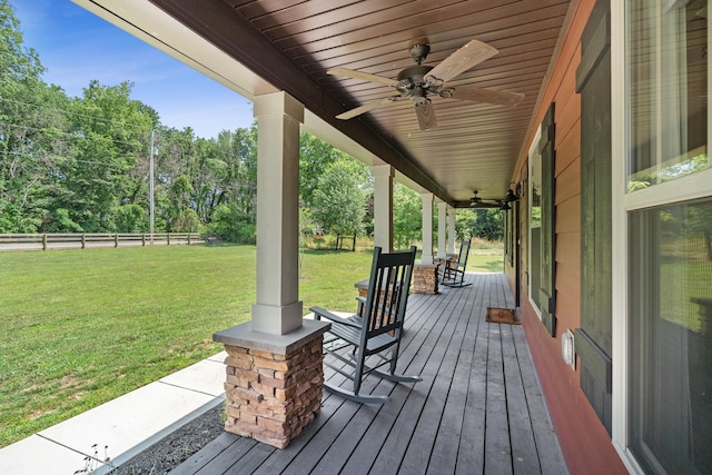 deck featuring a lawn and ceiling fan