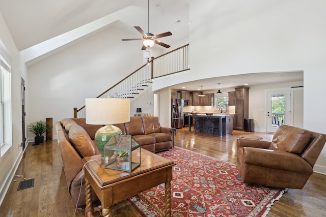 living room featuring high vaulted ceiling, ceiling fan, dark hardwood / wood-style floors, and sink