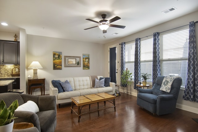 living room featuring ceiling fan and dark hardwood / wood-style floors