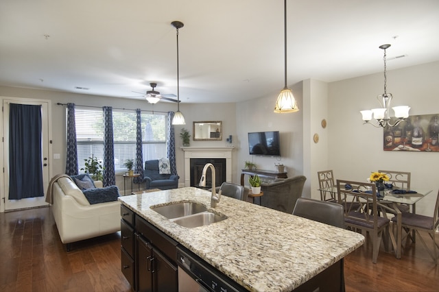 kitchen featuring sink, dark wood-type flooring, and hanging light fixtures