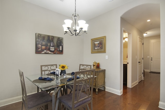 dining space featuring a notable chandelier and dark wood-type flooring