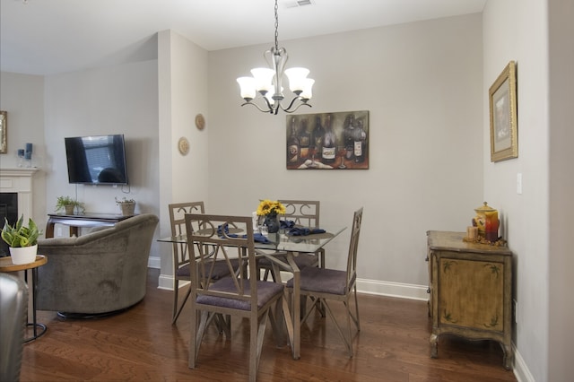 dining area with dark hardwood / wood-style flooring and a notable chandelier