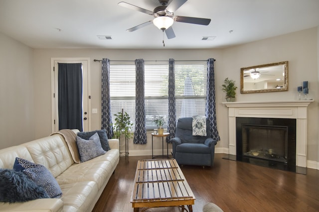 living room featuring ceiling fan and dark hardwood / wood-style floors