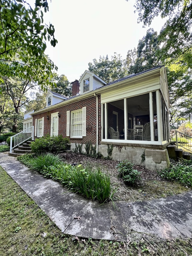 view of front of property featuring a sunroom