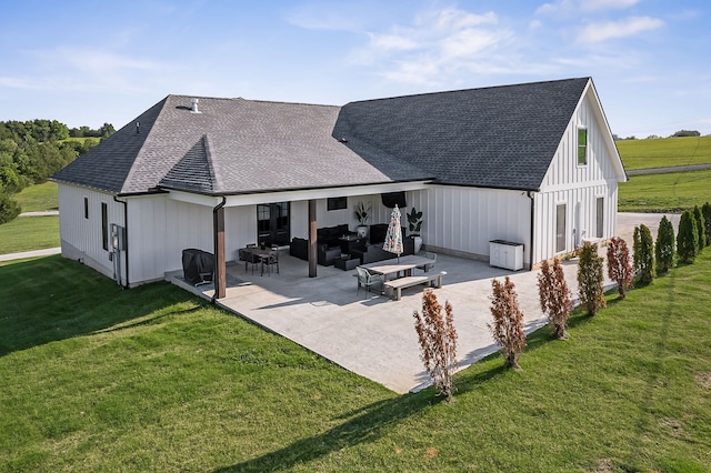 back of house with an outdoor hangout area, a yard, and a patio