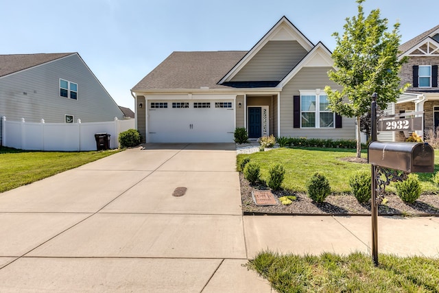 craftsman inspired home featuring a front yard and a garage