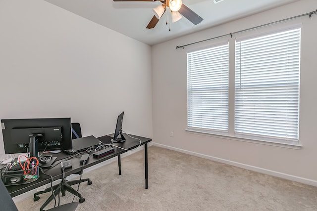 carpeted office space with ceiling fan