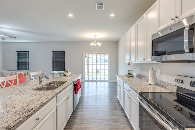 kitchen with light wood-type flooring, sink, appliances with stainless steel finishes, and white cabinetry