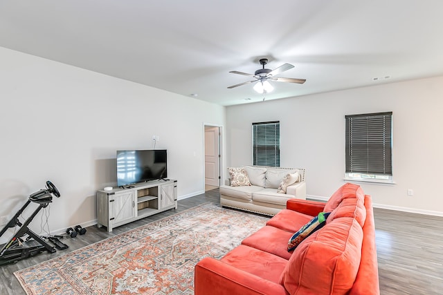 living room featuring ceiling fan and hardwood / wood-style flooring