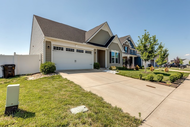 craftsman inspired home featuring a front yard and a garage