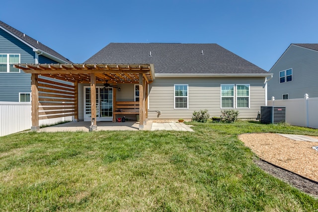 back of property with a patio, a pergola, central air condition unit, and a lawn