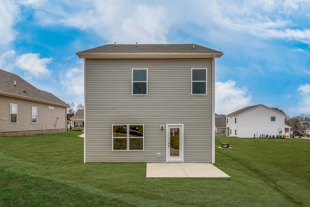 rear view of house featuring a yard and a patio area