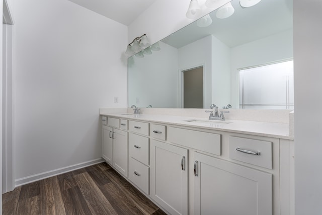 bathroom with dual sinks, hardwood / wood-style floors, and oversized vanity