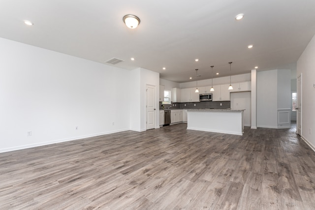 unfurnished living room featuring hardwood / wood-style flooring