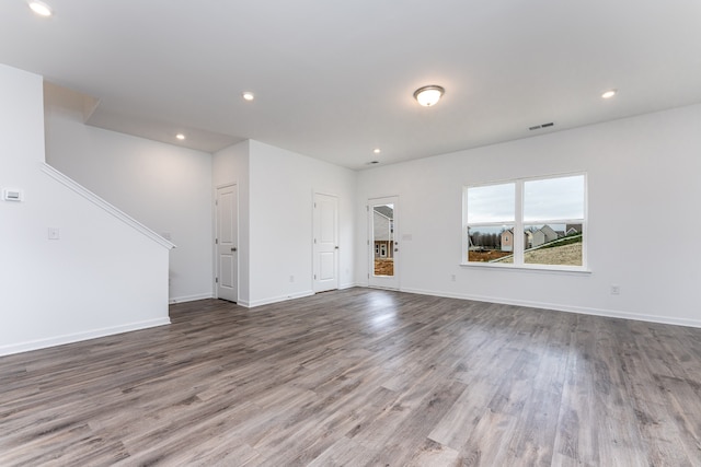 unfurnished living room featuring dark hardwood / wood-style floors