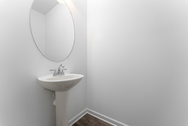 bathroom with hardwood / wood-style flooring