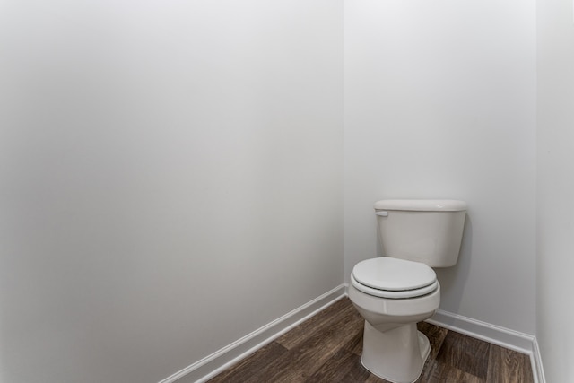 bathroom featuring toilet and wood-type flooring