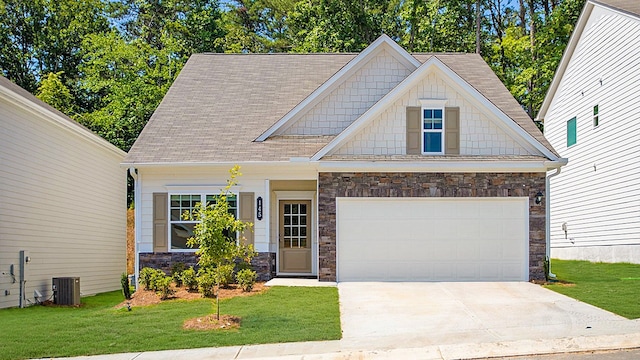 craftsman inspired home with a front lawn, a garage, and central AC unit