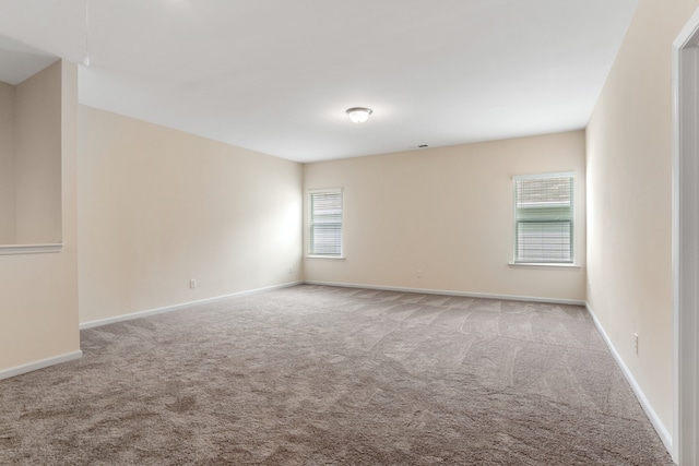 spare room with light carpet and plenty of natural light