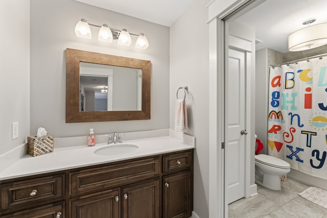 bathroom featuring tile floors, toilet, and vanity