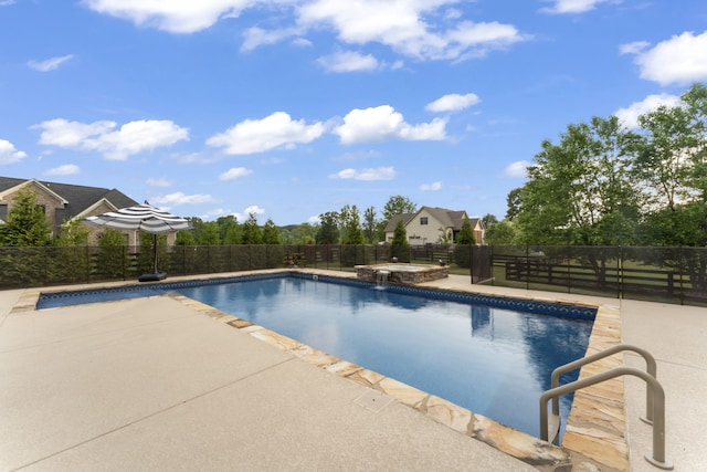 view of pool with a patio area and an in ground hot tub